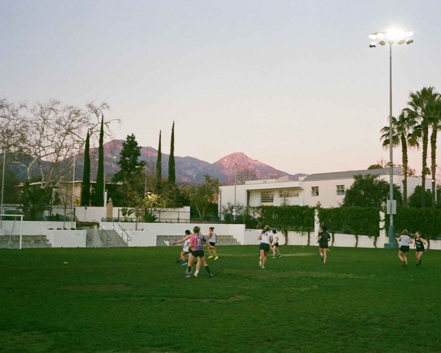 Greenshirts practice at Alumnae Field with the San Gabriel mountains behind them