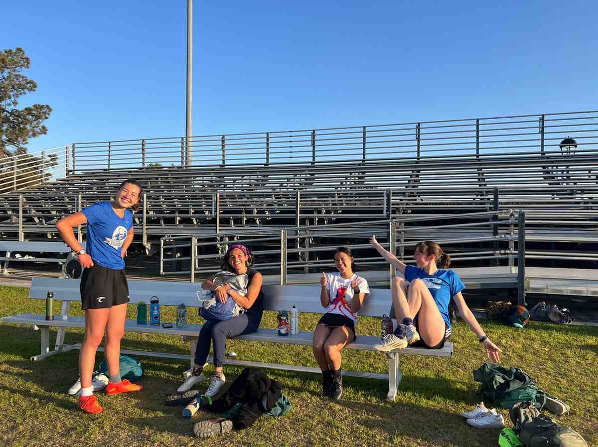 Four Greenshirts (Bubbles, Reggie, Dobby, and Tails) at a bench during practice at Merritt Field